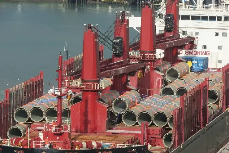 Steel pipes stowed as break bulk cargo between a vessel's deck cranes