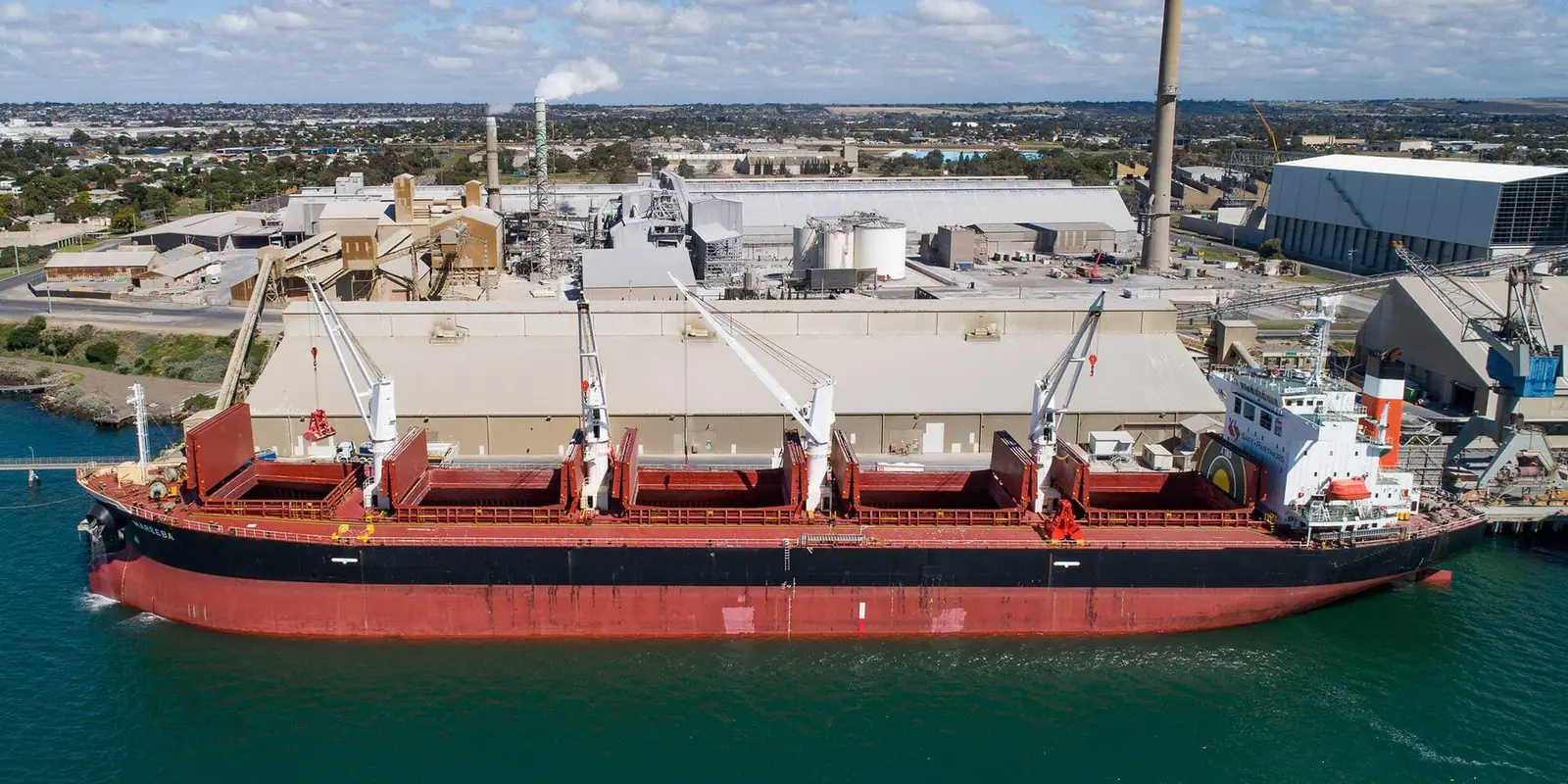 Geared bulk carrier moored at an industrial berth