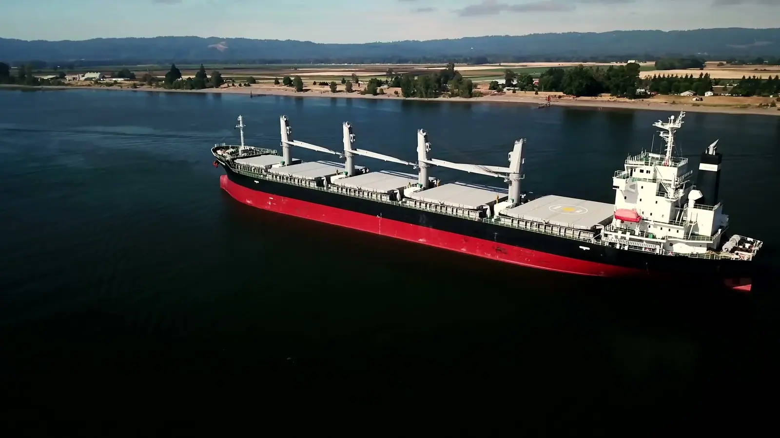 Aerial view of a geared bulk carrier at anchor