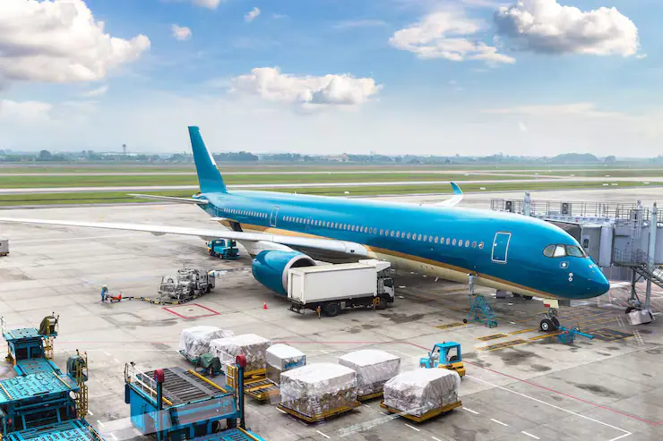 Aircraft at an airport stand with cargo pallets waiting to load
