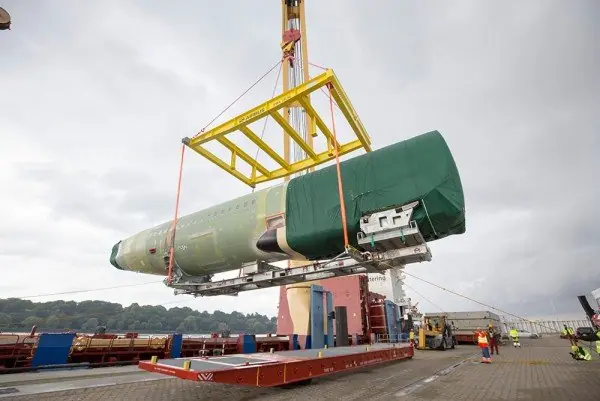 Heavy component lifted with a spreader frame at a port