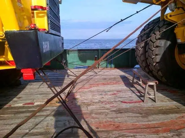 Dump truck secured on a barge deck