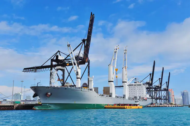 Cargo ship berthed beside port cranes
